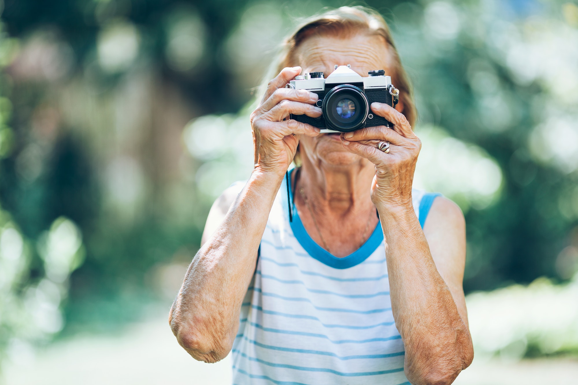 Elderly woman with a photo camera